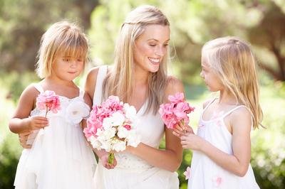 Bride and lovely flower girls in gardens